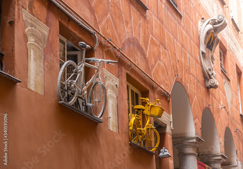 Art installation of two bicycles on the wall of a house in the city of Savona photo