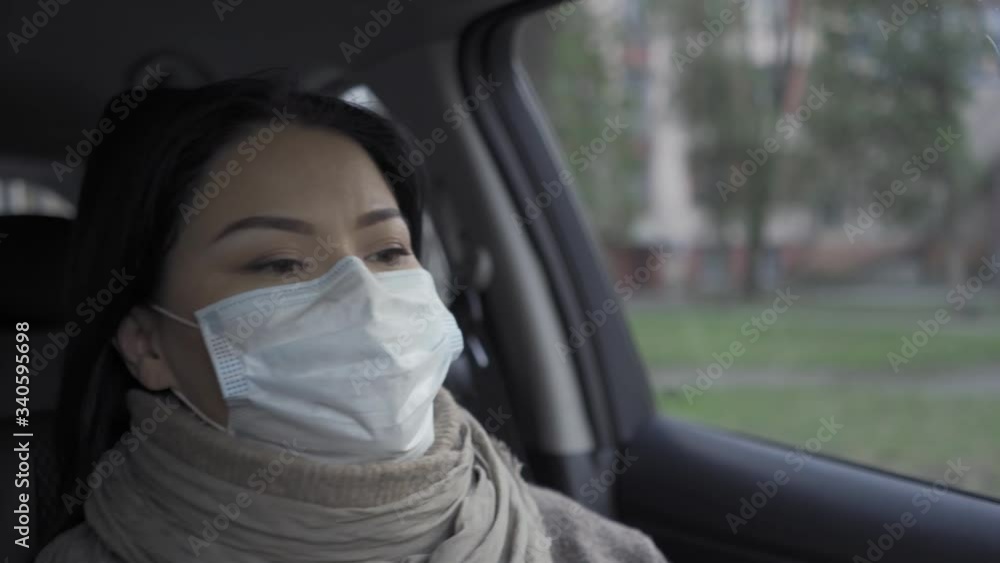 Asian doctor on the way to work driving car.
