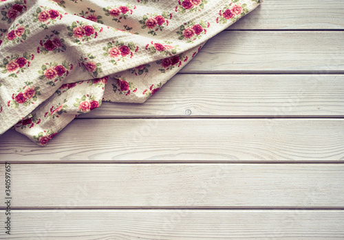 Vintage kitchen tablecloth on rustic wooden table made of white wood planks. Textured background with copy space for your advertising text message or promotional content