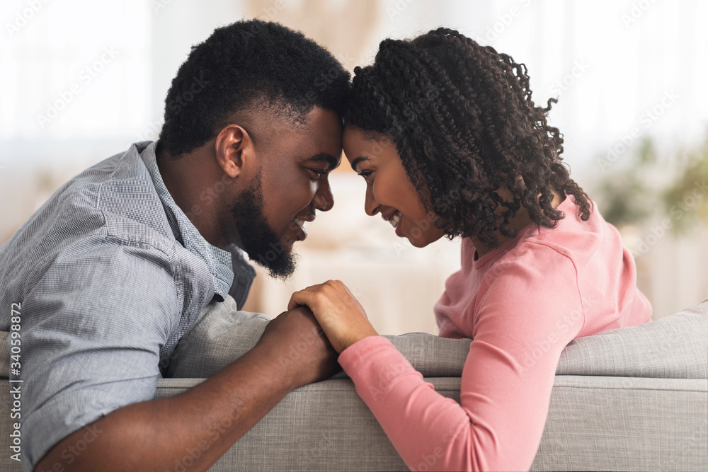 Obraz premium Romantic Black Couple Bonding At Home, Holding Hands And Touching Foreheads