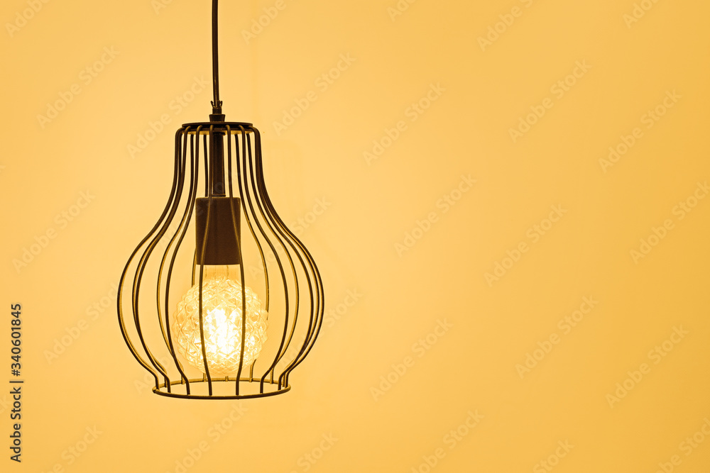 modern interior lamp with a retro lamp on a yellow background, the concept of home comfort and interior