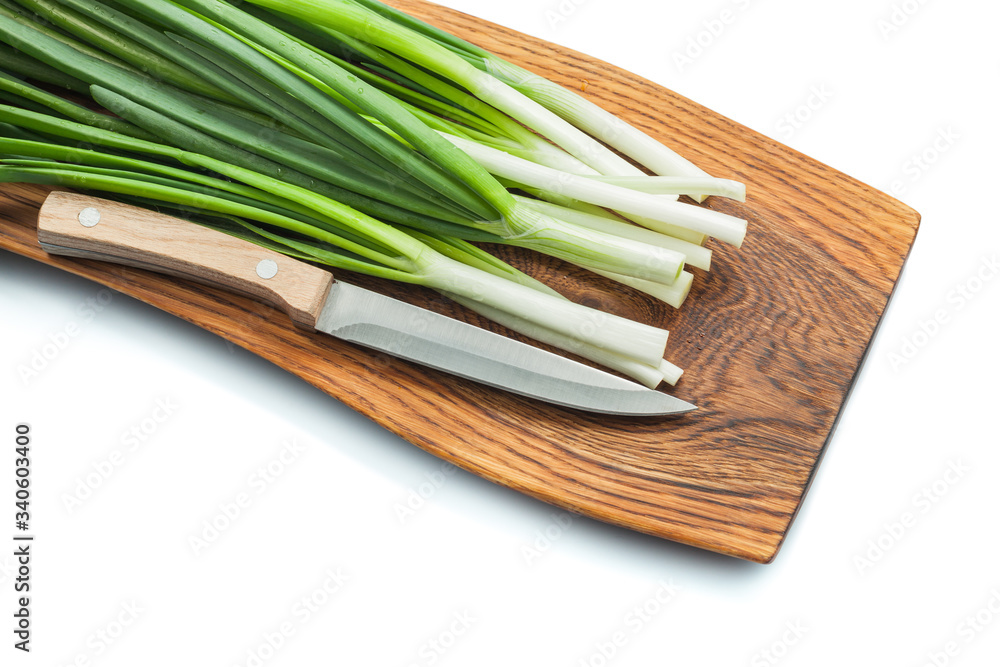 green spring onion scallion stems with kitchen knife on wooden cutting board isolated white green spring onion scallion stems with kitchen knife on wooden cutting board isolated white