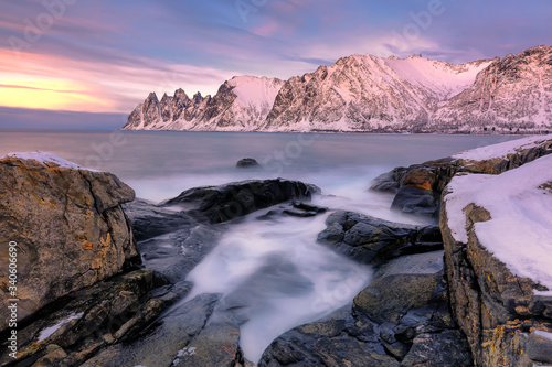 The rocky beach and pools at sunset on Ersfjord. Senja island in the Troms region of northern Norway. Long exposure shot © Olga