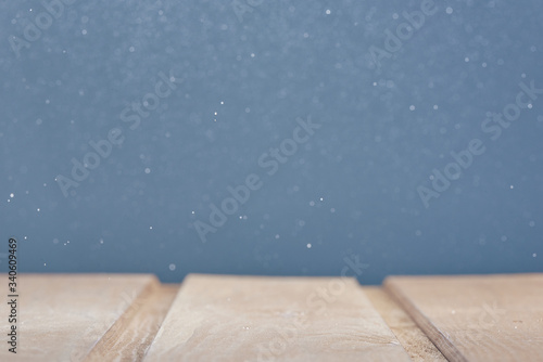 Wooden surface on a blue background with bokeh in blur. Photo from copy space.