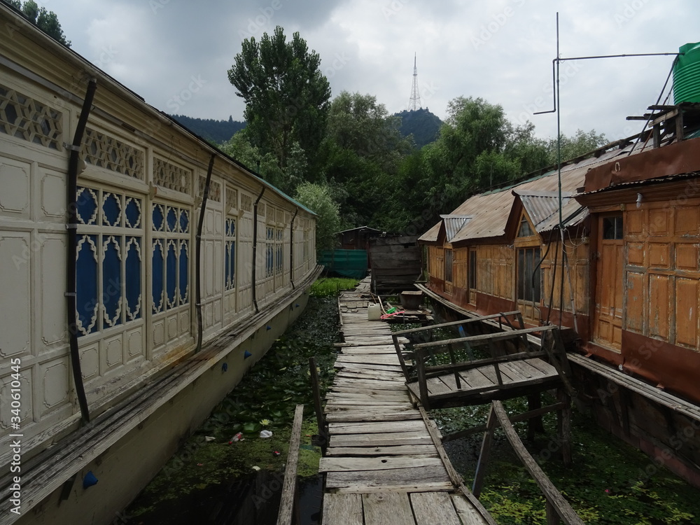 wooden bridge between old houseboats