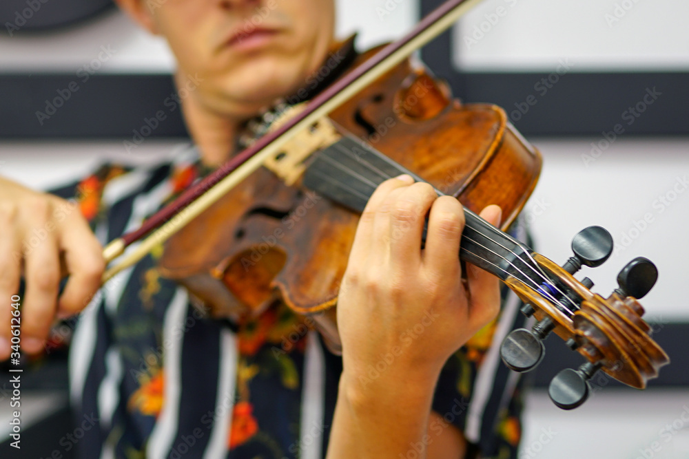 Young musician playing the violin, Close Up, Playing his handmade violin with great success Young musician playing the violin, Close Up, Playing his handmade violin with great success