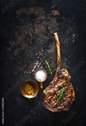 Grilled tomahawk beef steak with spices photo
