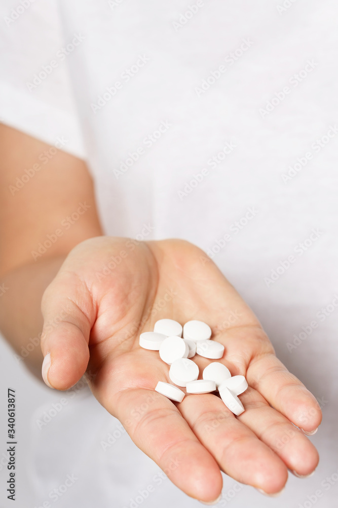 Female hand with a handful of pills Female hand with a handful of pills