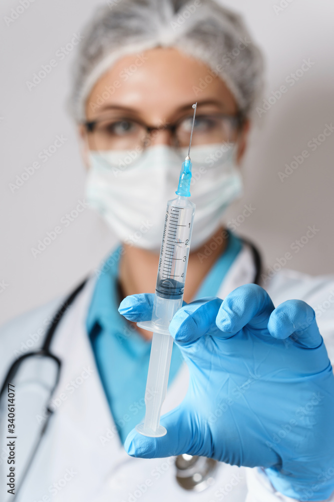 Doctor is holding syringe with a vaccine or medicine Doctor is holding syringe with a vaccine or medicine