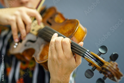 Musician playing violin with Pizzicato technique, close up