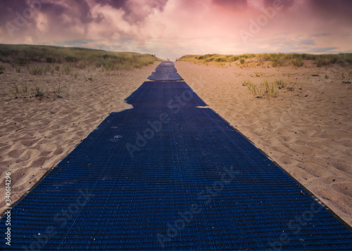 Fototapeta Naklejka Na Ścianę i Meble -  Blue carpet on sand with sky