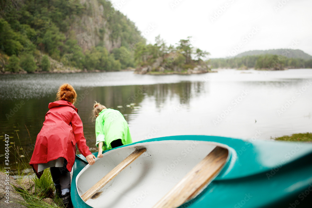 mother and daughter taking kayak on lake mother and daughter taking kayak on lake
