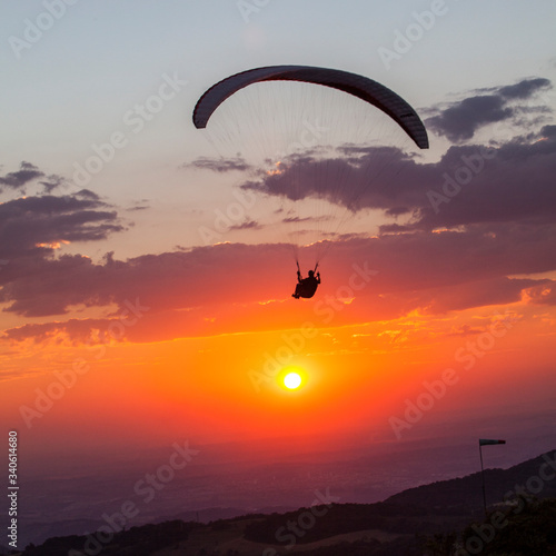 paragliding flying at beautiful sunset