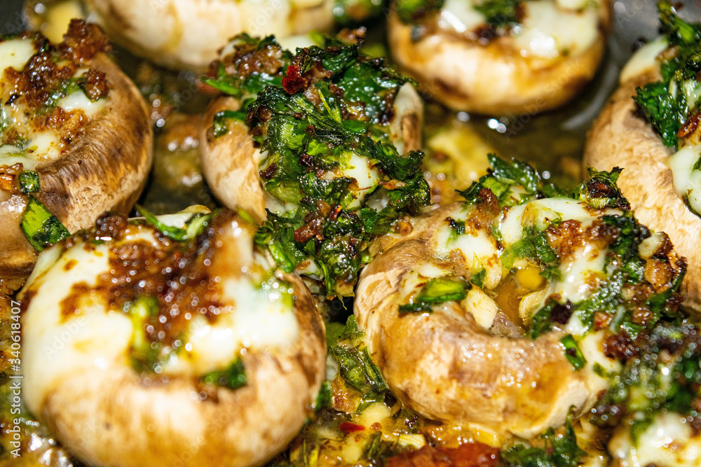 Mushrooms baked in the oven with cheese, green onions and dill. Close up. Mushrooms baked in the oven with cheese, green onions and dill. Close up.