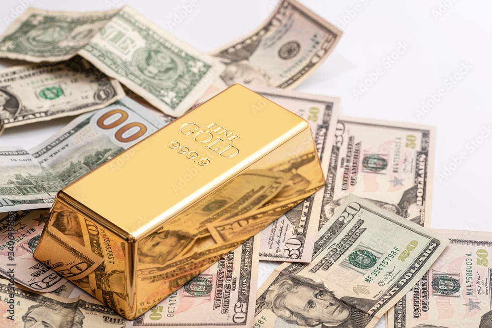 Gold bar and US dollar bills Gold bar and US dollar bills