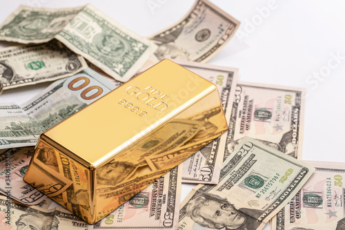 Gold bar and US dollar bills
