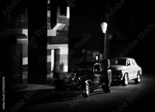 The mood of the film noir - street photo on a micro scale using blocks and other toys. Intentional high grain and noise, selective focus (shallow depth of field).