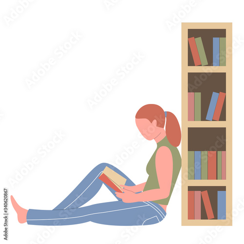 Reading girl sitting on the floor near a bookcase