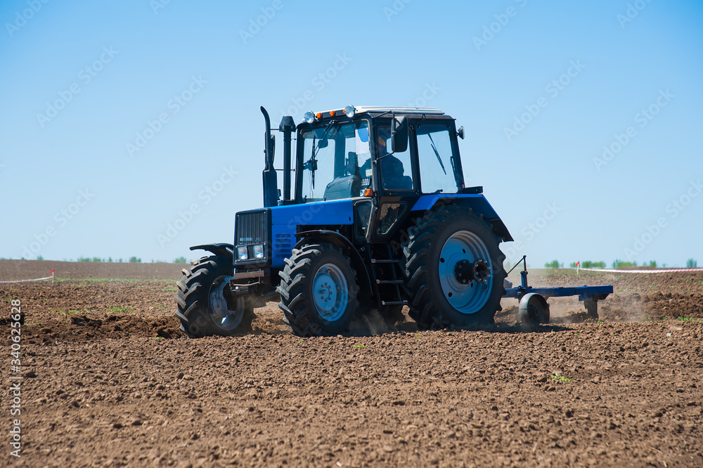 Fototapeta premium Agriculture with a tractor