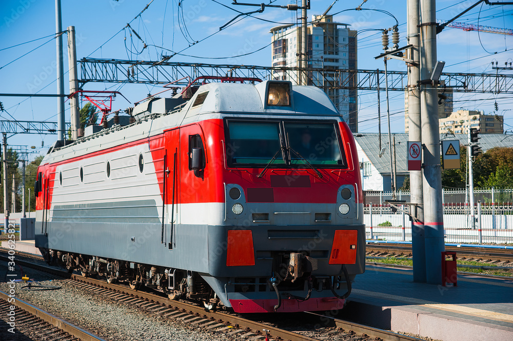 The locomotive of the train arrives at the station