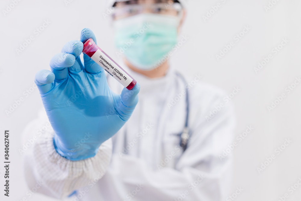 Fototapeta premium Coronavirus (COVID-19) testng concept, The doctor holds a test tube containing a blood sample..