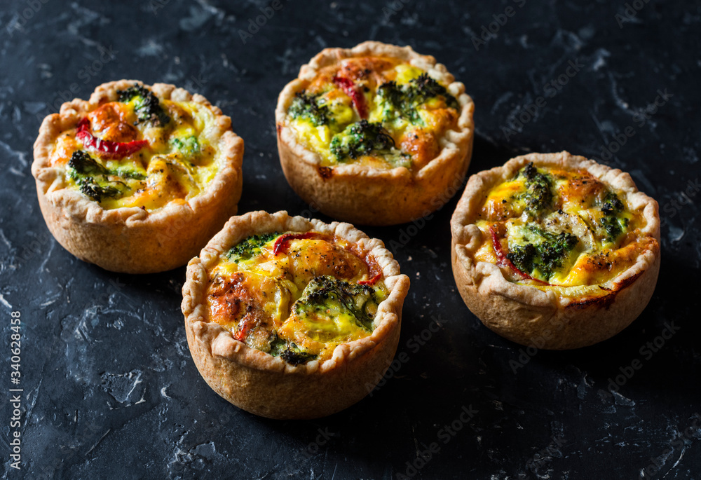 Broccoli, ham, cheddar pies on dark background, top view. Delicious appetizers, snack, tapas
