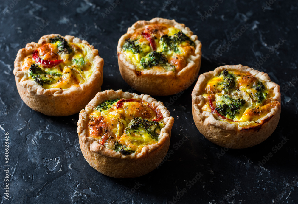 Broccoli, ham, cheddar pies on dark background, top view. Delicious appetizers, snack, tapas Broccoli, ham, cheddar pies on dark background, top view. Delicious appetizers, snack, tapas