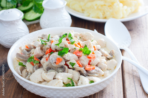 Chicken fillet with mushrooms in sour cream sauce, selective focus