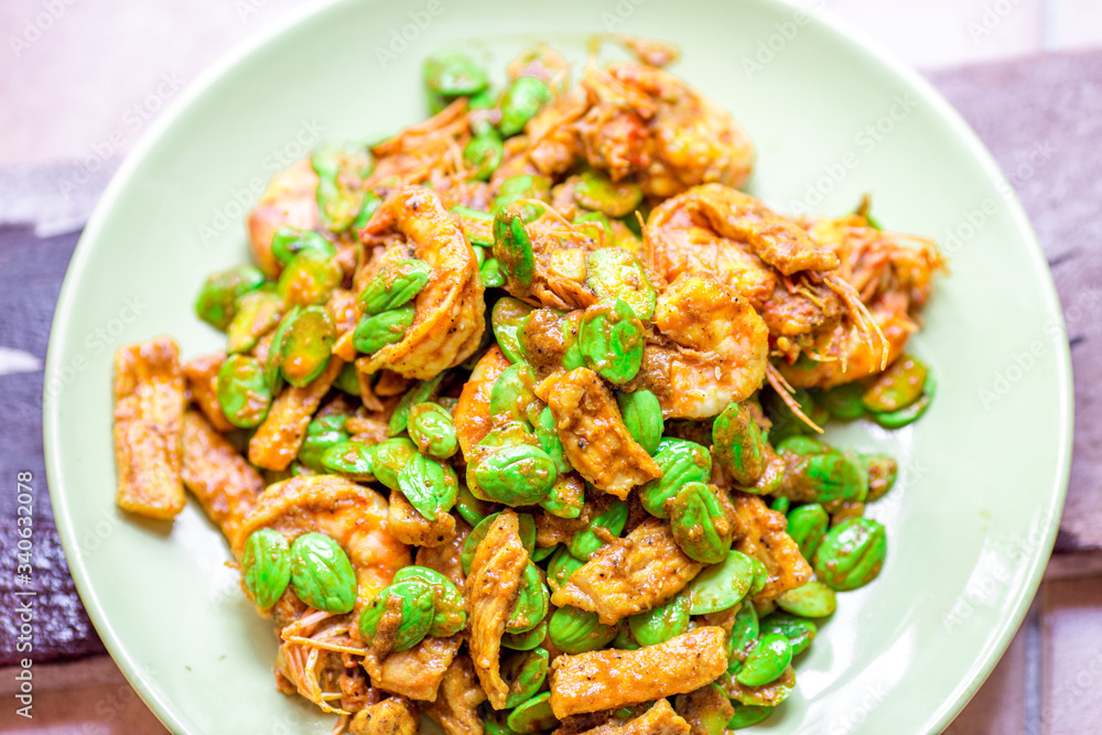 blurred background view of the spicy southern Thai food(stir-fried spicy Sato with fresh prawns),which has a mixture of colorful spices catching the customers, a popular menu eaten with steamed rice blurred background view of the spicy southern Thai food(stir-fried spicy Sato with fresh prawns),which has a mixture of colorful spices catching the customers, a popular menu eaten with steamed rice