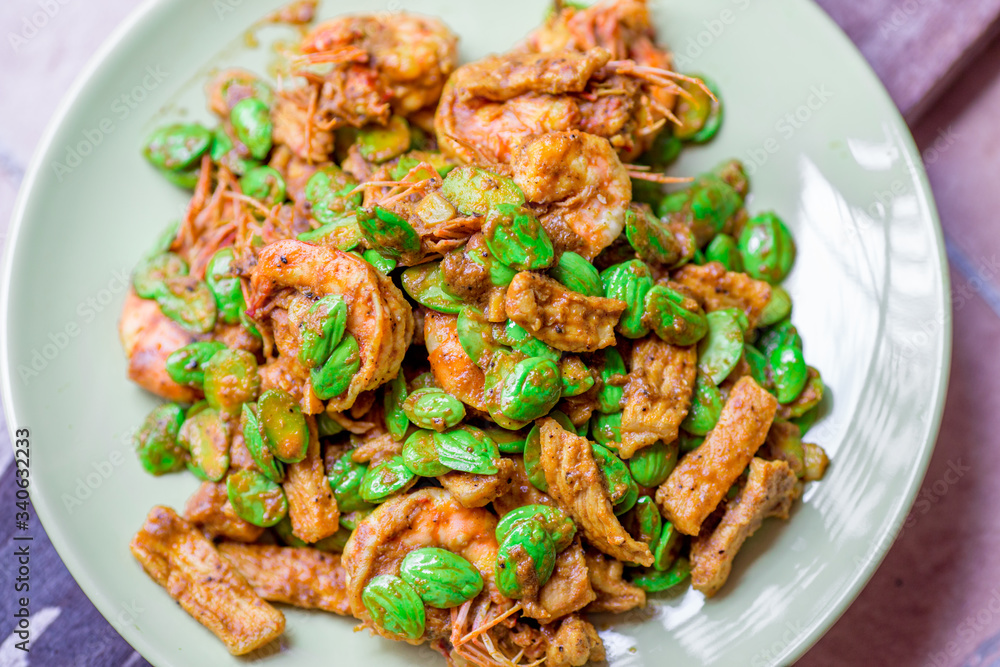 blurred background view of the spicy southern Thai food(stir-fried spicy Sato with fresh prawns),which has a mixture of colorful spices catching the customers, a popular menu eaten with steamed rice blurred background view of the spicy southern Thai food(stir-fried spicy Sato with fresh prawns),which has a mixture of colorful spices catching the customers, a popular menu eaten with steamed rice