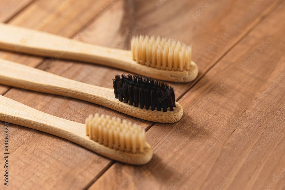 Bamboo toothbrushes on the wooden surface Bamboo toothbrushes on the wooden surface