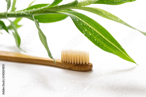 Bamboo toothbrush on white background