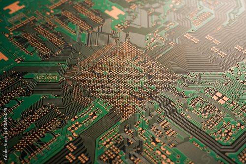 A close-up of black Green coloured Printed circuit board (PCB) with no component mounted (copper exposed)