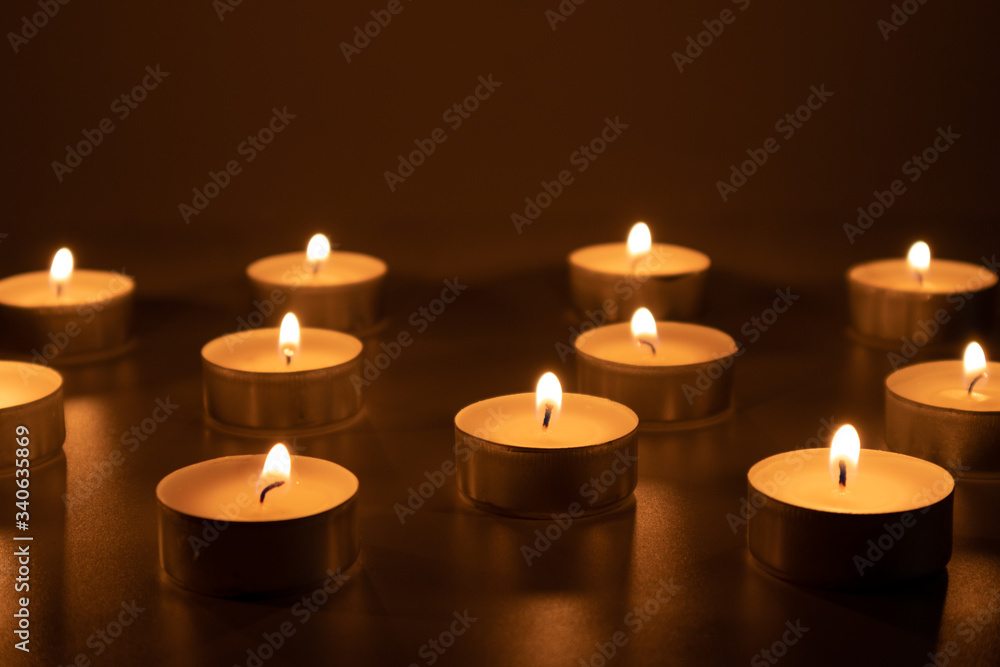 Fire flames of small candles, shadowy, catholic and christian scene Fire flames of small candles, shadowy, catholic and christian scene