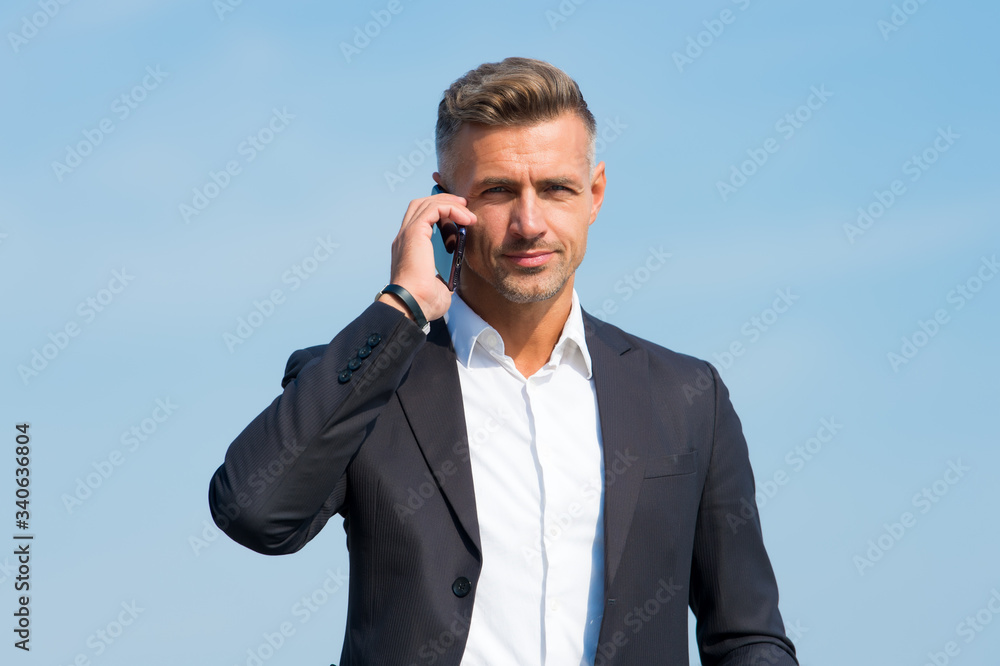 Hello, answer the phone. Businessman call on mobile phone. Handsome man with cell phone outdoors. Business communication. Phone for professional use. 3G. 4G. Mobile lifestyle. New technology Hello, answer the phone. Businessman call on mobile phone. Handsome man with cell phone outdoors. Business communication. Phone for professional use. 3G. 4G. Mobile lifestyle. New technology