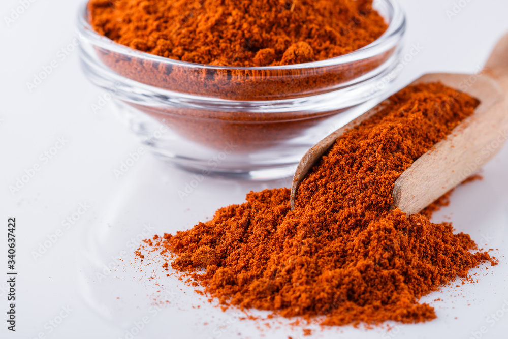 aromatic spicy chili powder on a white background aromatic spicy chili powder on a white background