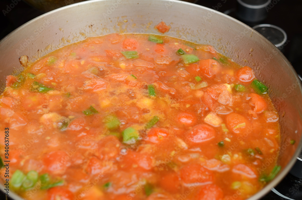 A cooking tomato sauce on pan A cooking tomato sauce on pan