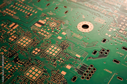 A close-up of black Green coloured Printed circuit board (PCB) with no component mounted (copper exposed) photo
