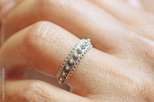 Hand wearing elegant silver ring in oriental shape © marbenzu