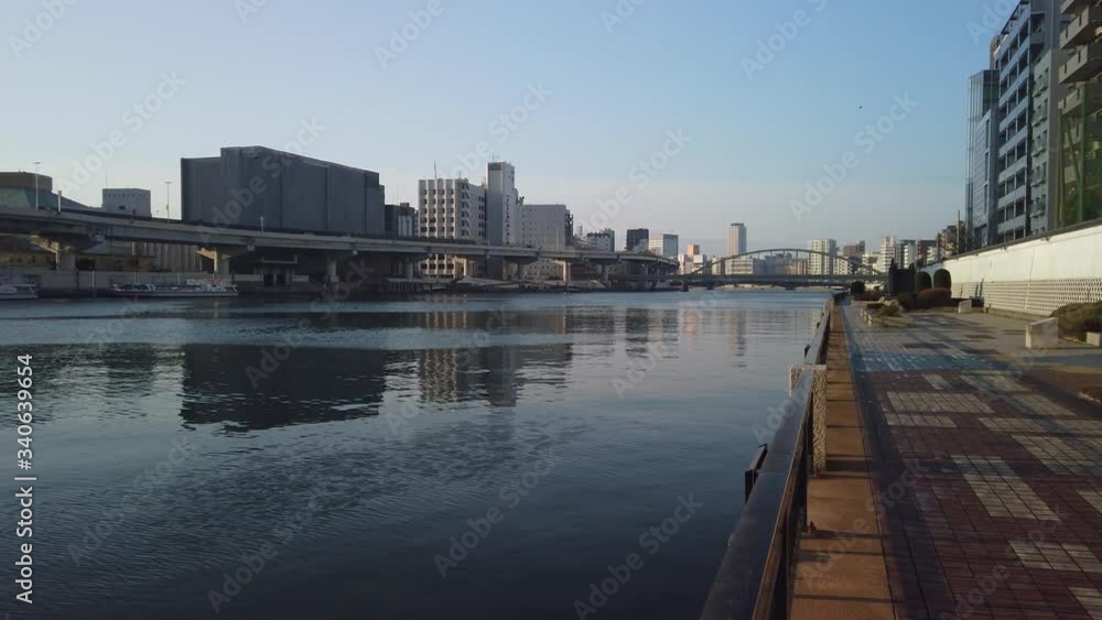Sumida River walk, pan across Tokyo establishing shot at sunrise Sumida River walk, pan across Tokyo establishing shot at sunrise