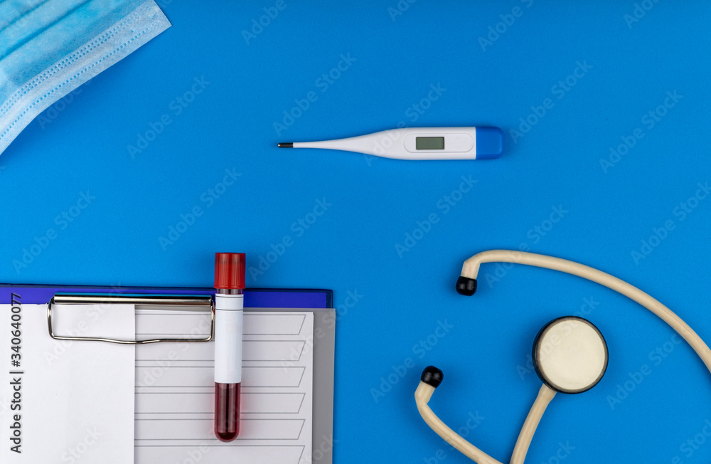 Flat lay composition with blood test tube and electronic thermometer on blue background. Flat lay composition with blood test tube and electronic thermometer on blue background.