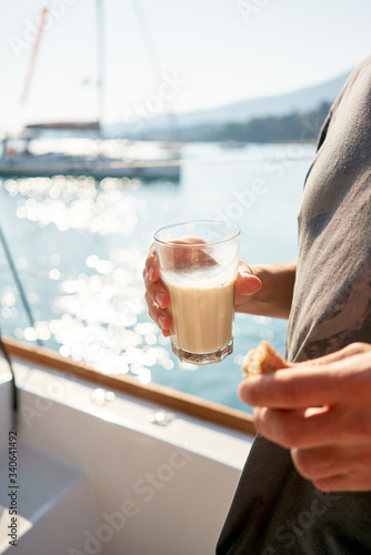 Glass of milk on the yacht. Morning, healthy breakfast.
