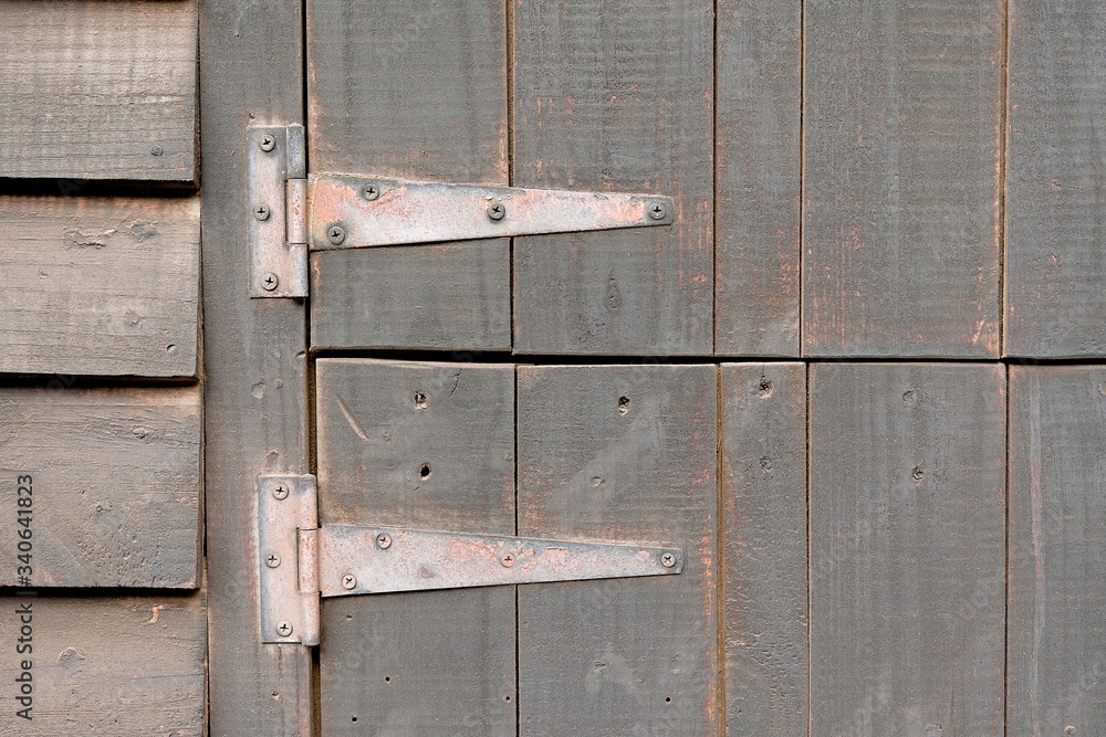 two old rusty metal hinges screwed to holding a stable door two old rusty metal hinges screwed to holding a stable door