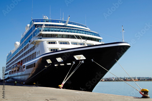 Azamara Club Cruises cruiseship or cruise ship liner Azamara Pursuit in port with pier and reflection on water on summer day in Montevideo, Uruguay during South American cruising photo