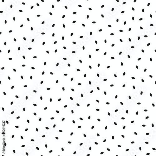 Seamless pattern, small ovals, ellipses scattered randomly. Black elements on a white background. Stylish design. Background. Vector illustration.