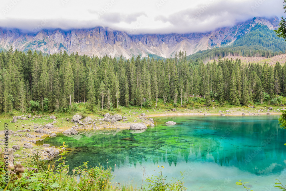 Lago di carezza or karersee is a stunning lake in the dolomites mountains in the north of Italy.