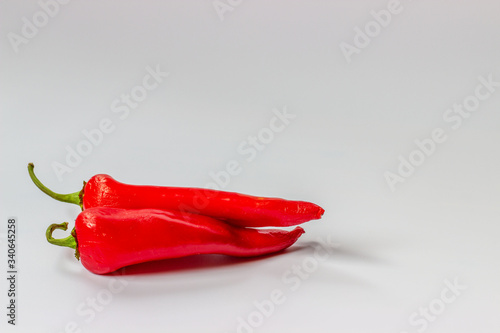 Ugly spoiled organic pepper on a white background with copy space. Food waste concept. Horizontal orientation.