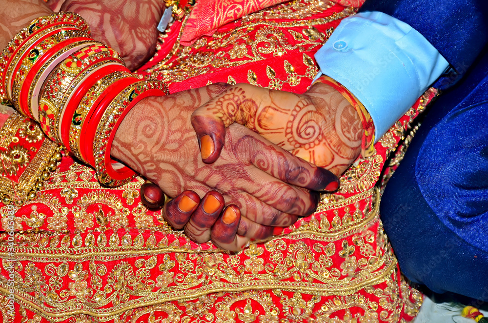 Indian bride and groom hand in traditional