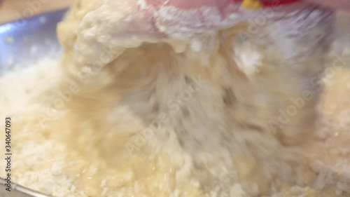 woman's hands close up kneading dough