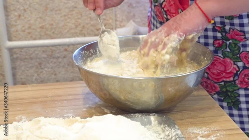 woman's hands close up kneading dough